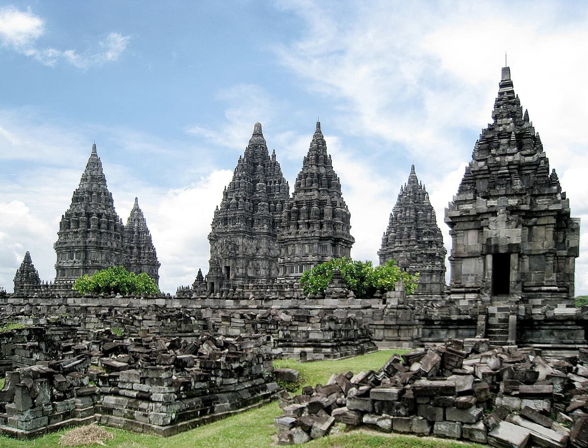 The Prambanan temple complex with fallen stone blocks in the foreground