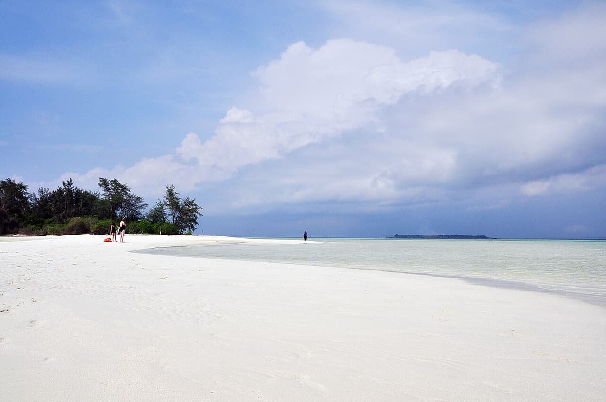 A white sand spit and clear shallow water on a small island in Karimunjawa